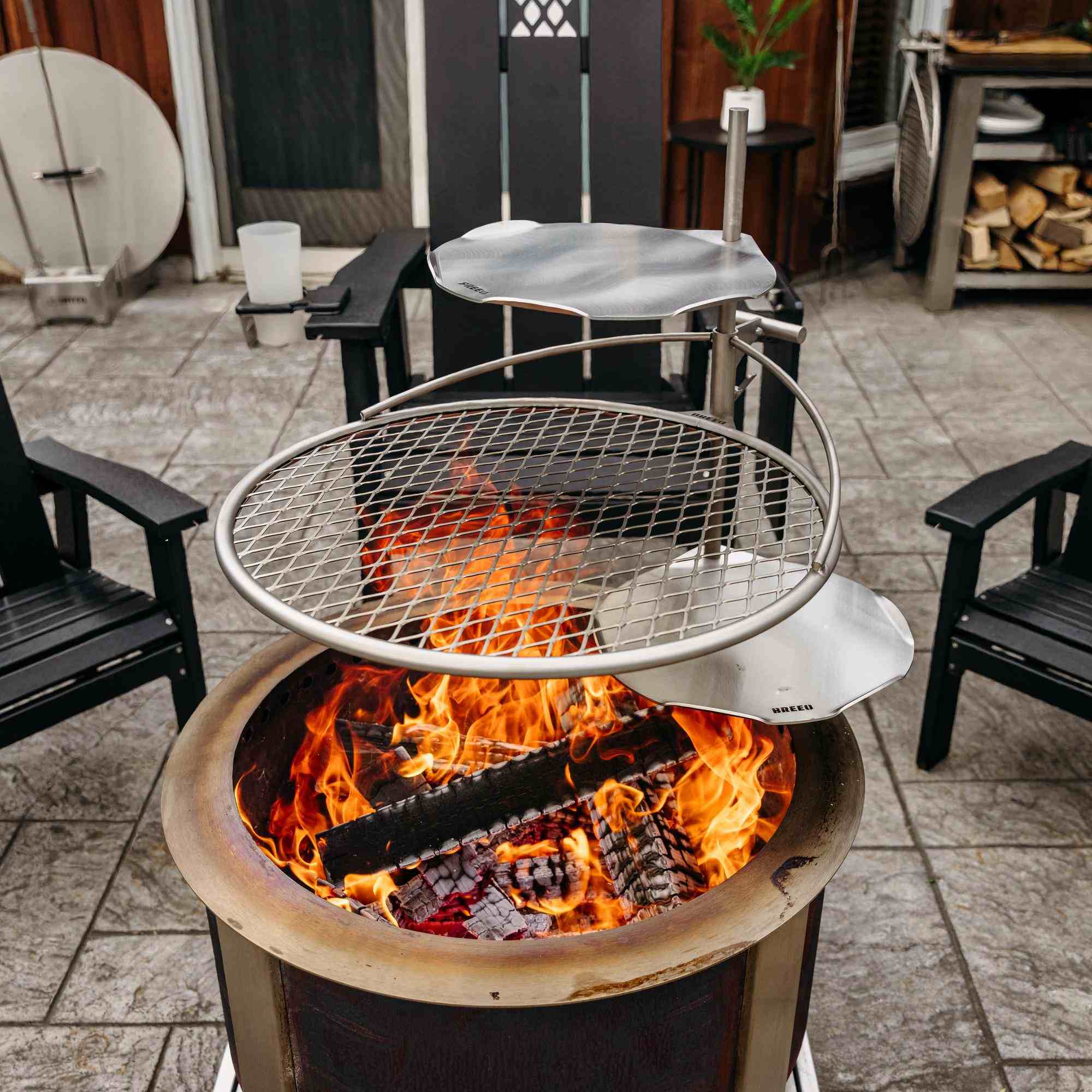 This is an image of the X24 Corten firepit with an Outpost Grill and two Sear Discs attached.