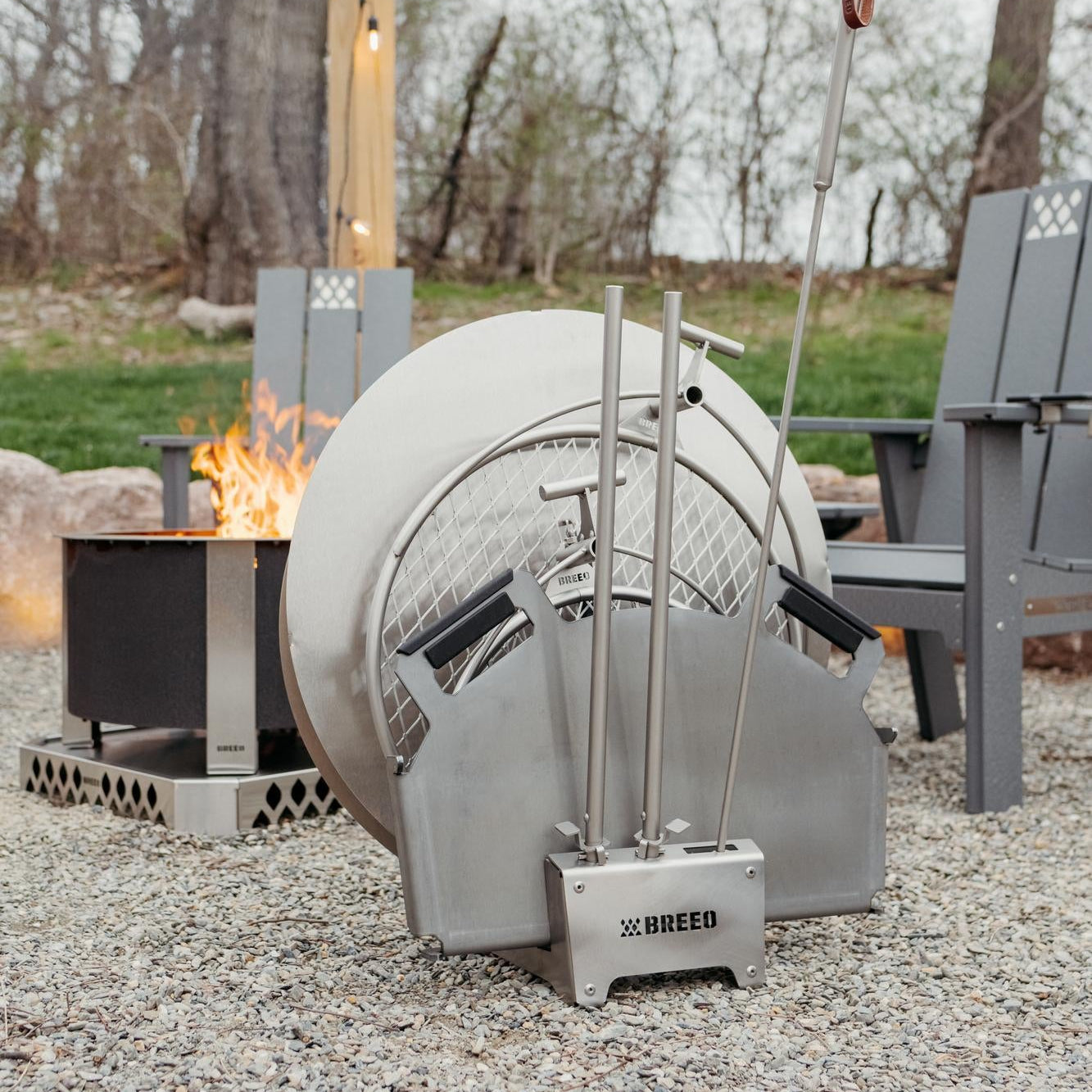 Outdoor fire pit with a metal barrel design, featuring the brand 'BREEO'.