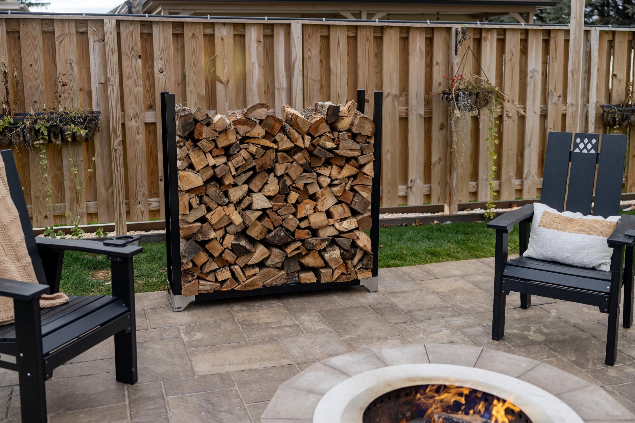 This is an image of wood stacked on the firewood rack without a cover.