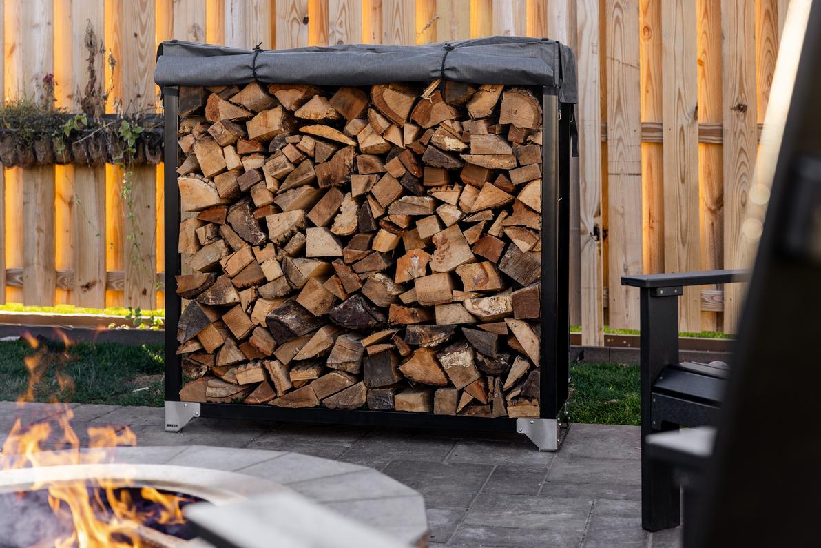 Image of a Breeo Firewood Rack with wood stacked on it.