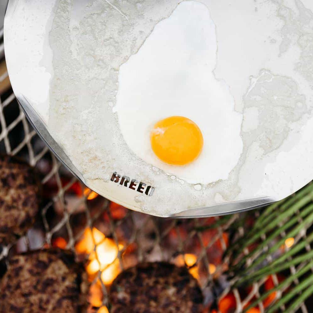This is an image of an egg frying on a Breeo Outpost Sear Disc