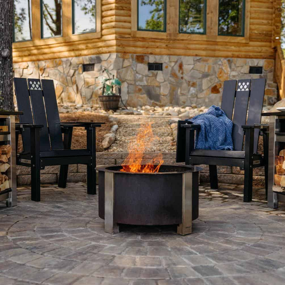 Father and son gray x series chairs on patio around corten breeo firepit