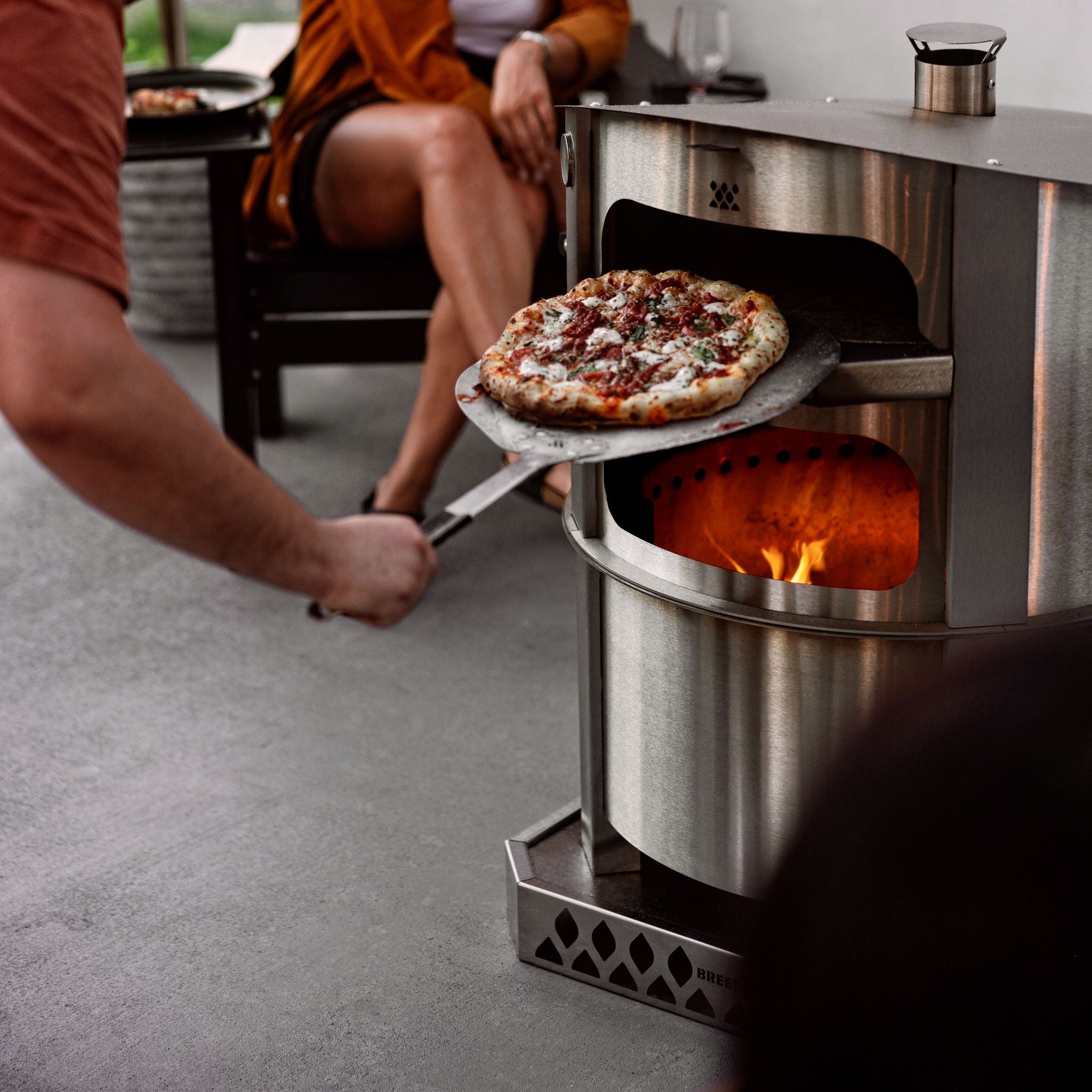 Removing pizza with a Breeo Pizza Peel