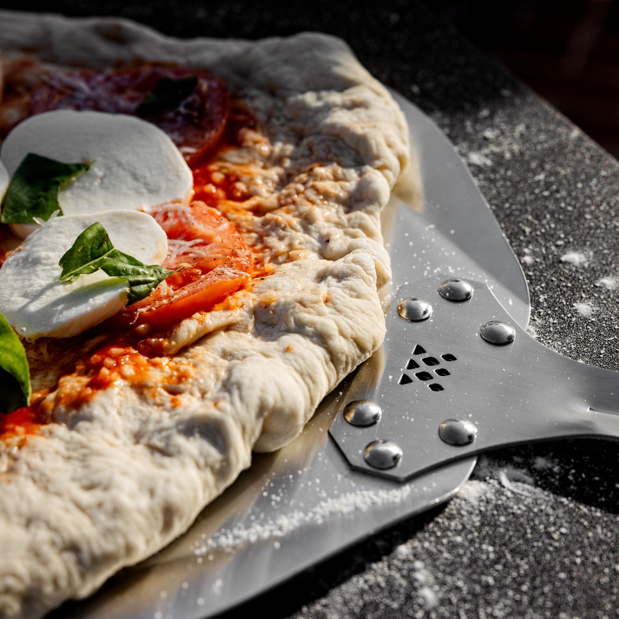 Breeo Pizza Peel with a pizza ready to bake