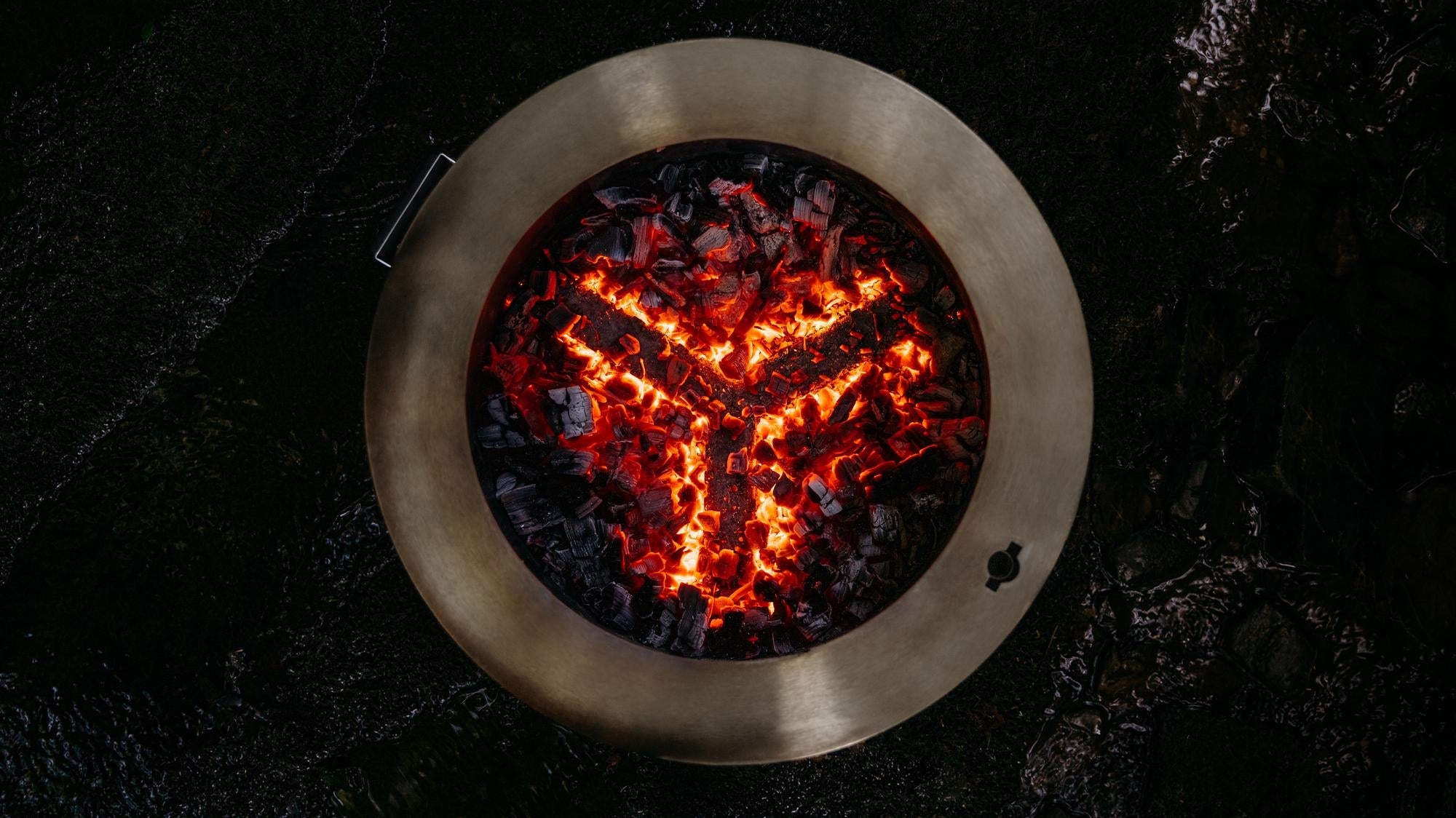 An image of a Y Series firepit with burning coals. 