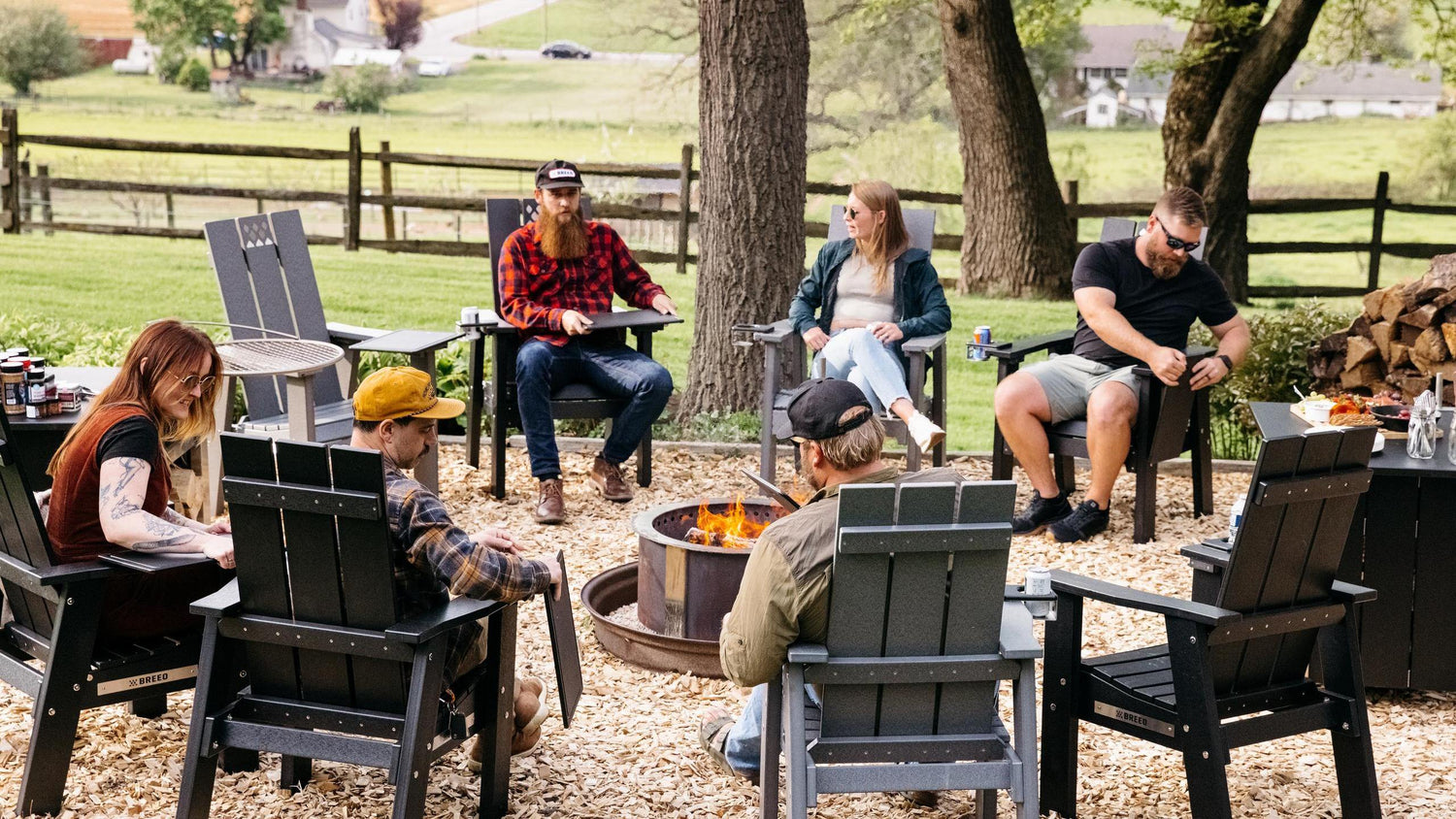 Gathering around a Breeo fire pit with X Series furniture 