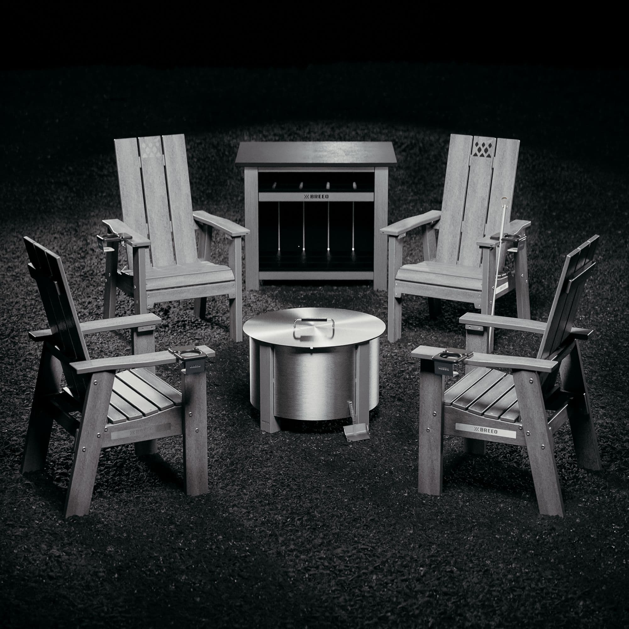 An image of the Fireside Furniture collection with an X Series Stainless firepit, including 4 Breeo chairs, an X Series Table, cupholders, tray tables, and a firepit and lid. 