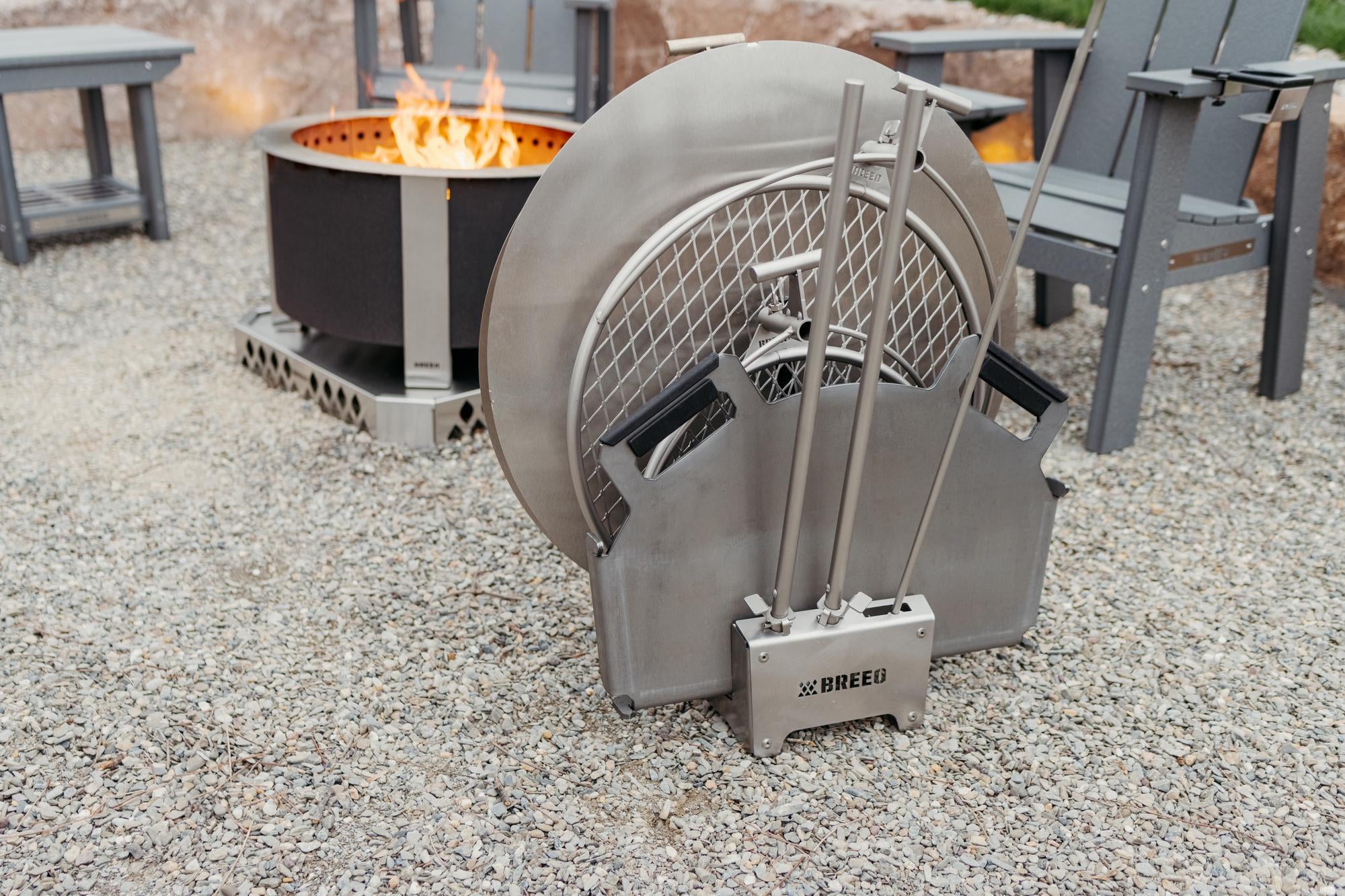 Breeo 304 Dock with a metal basket and tools on a gravel surface.