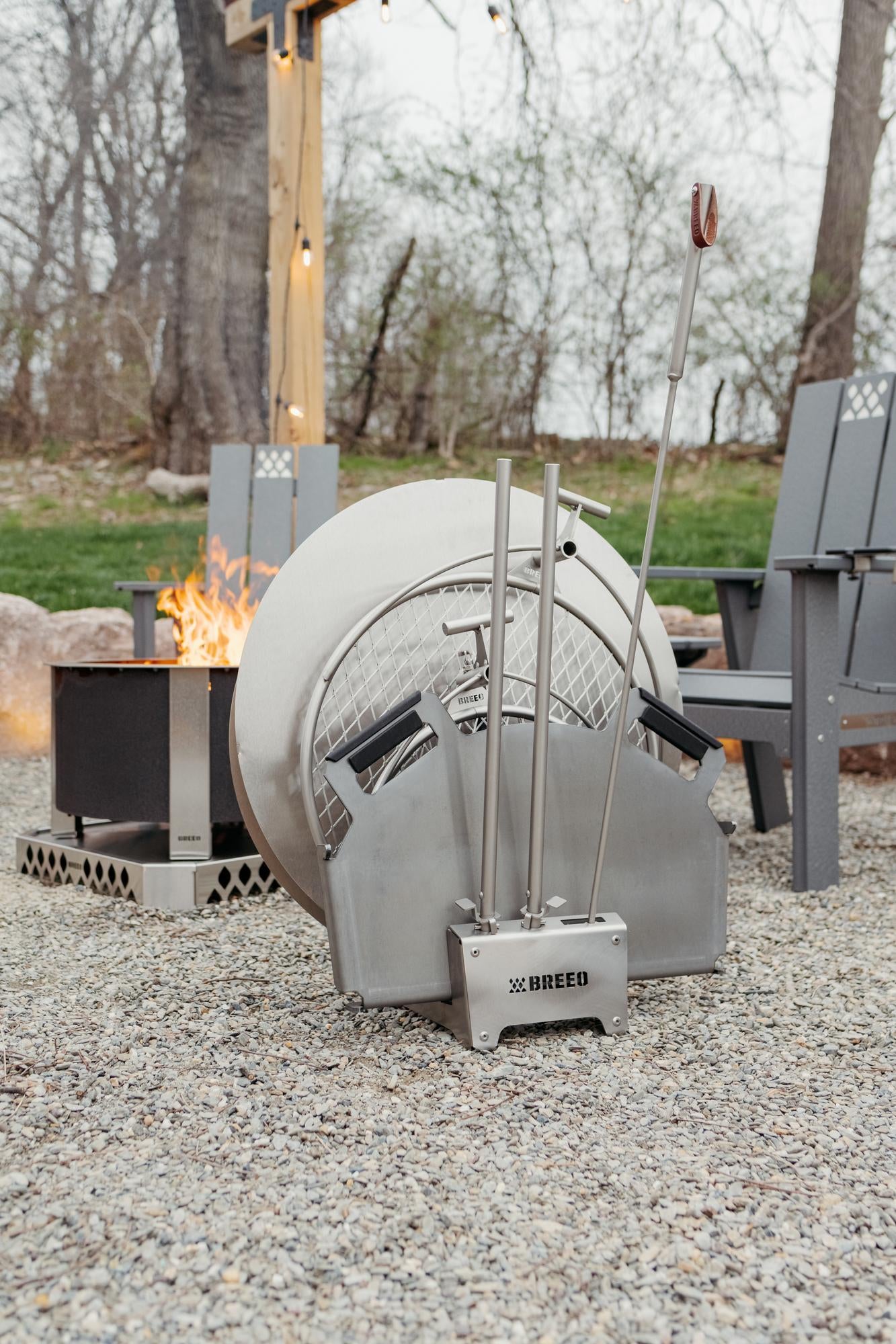 Outdoor fire pit with a metal barrel design, featuring the brand 'BREEO'.
