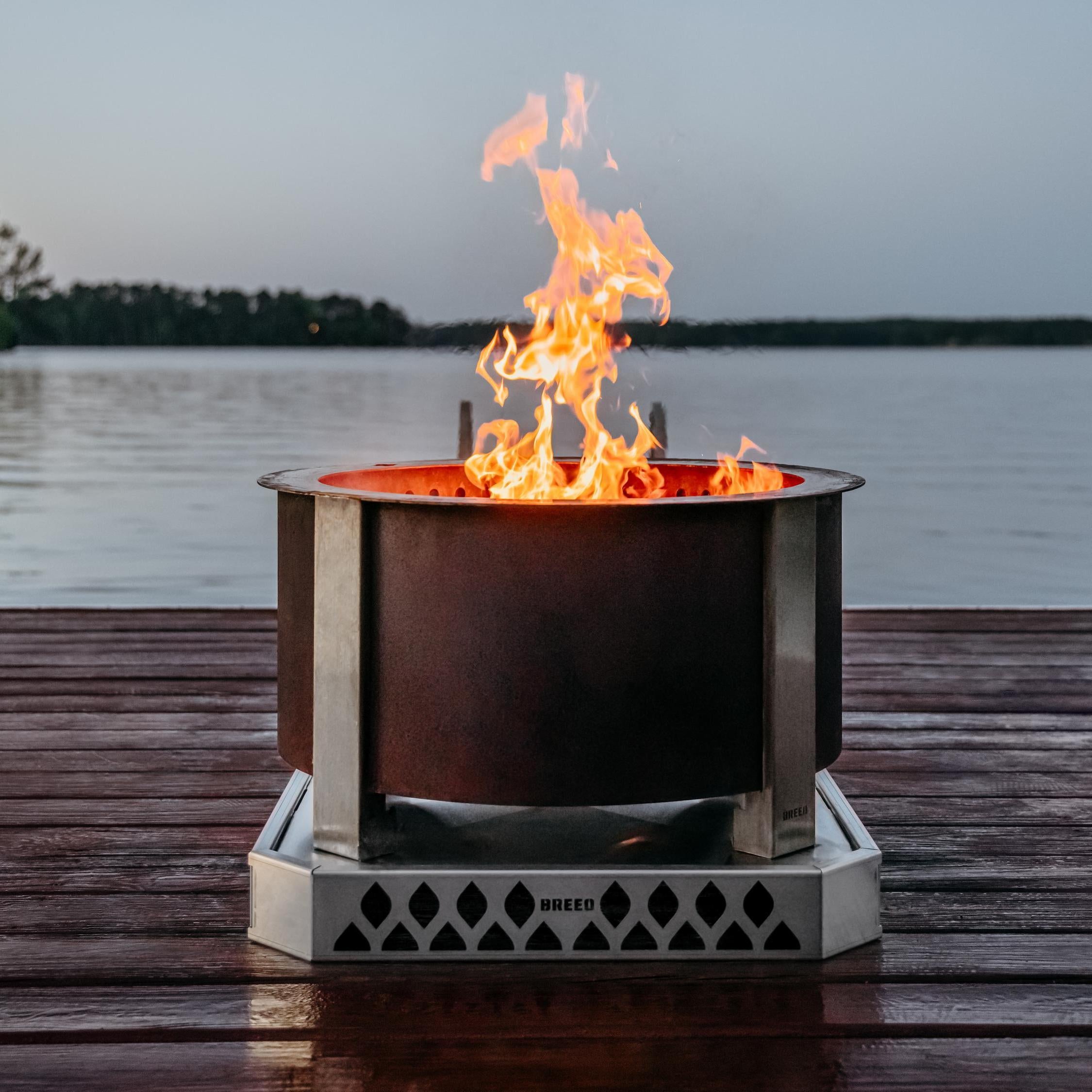 Breeo corten firepit on a dock with water in the background 