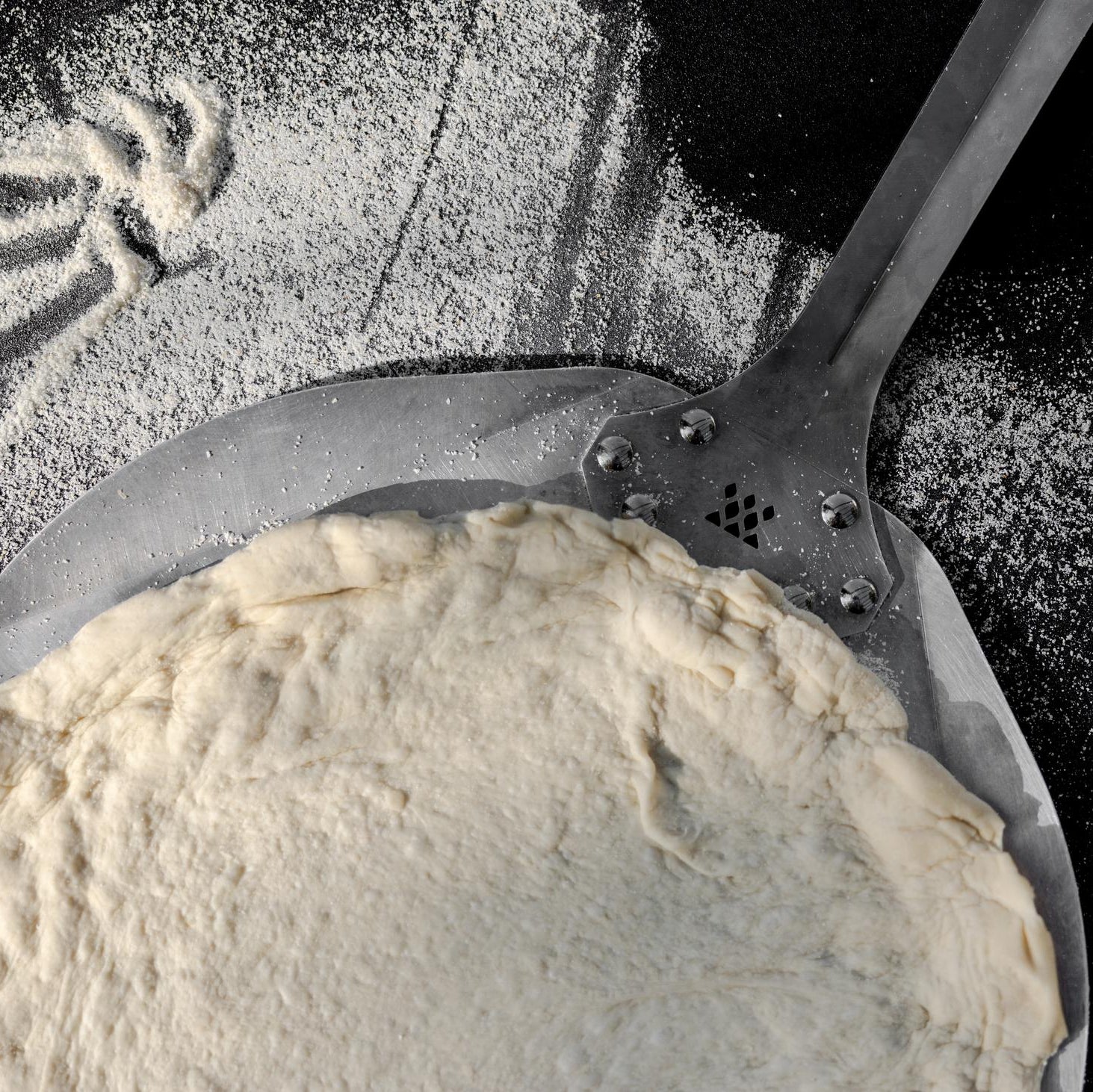 This is an image of pizza dough on a Pizza Peel