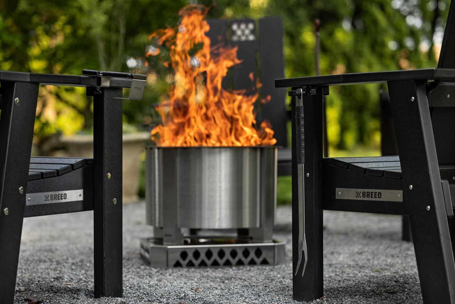 Breeo X Series Chairs arranged around a Breeo X24, with a Tri-hook attached to hang the Breeo Fork