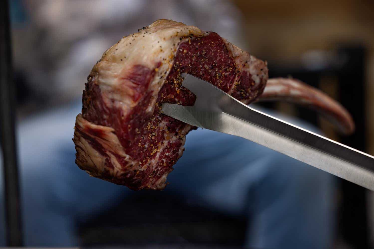 Using the Breeo Fork to pick up a steak from the grill