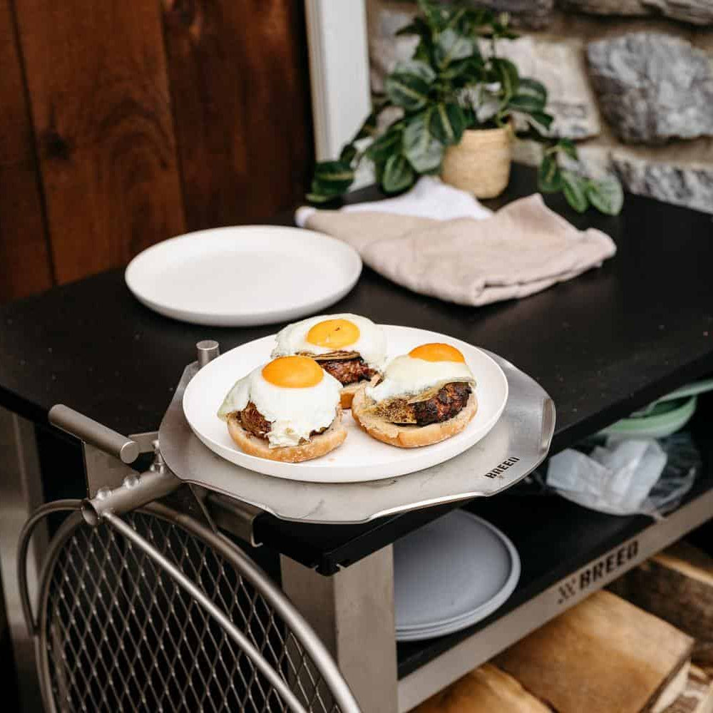This is an image of a grilled burgers resting on an Outpost Sear Disc attached to an X Series Table