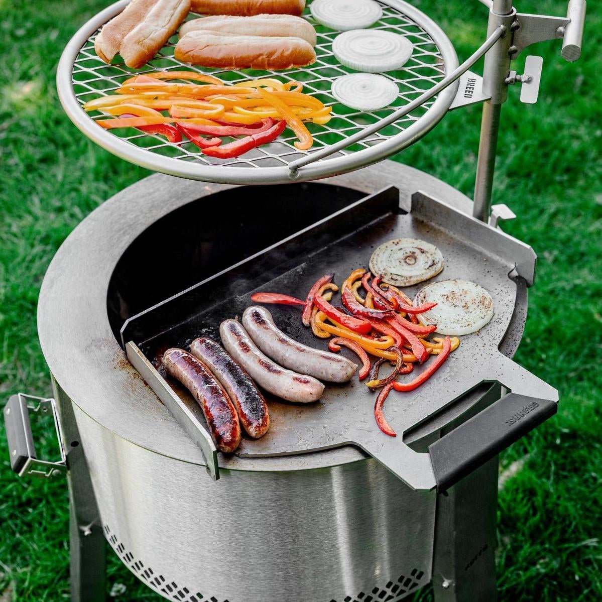 This is an image of the Y Series firepit set up with a Flat Top and Outpost Grill