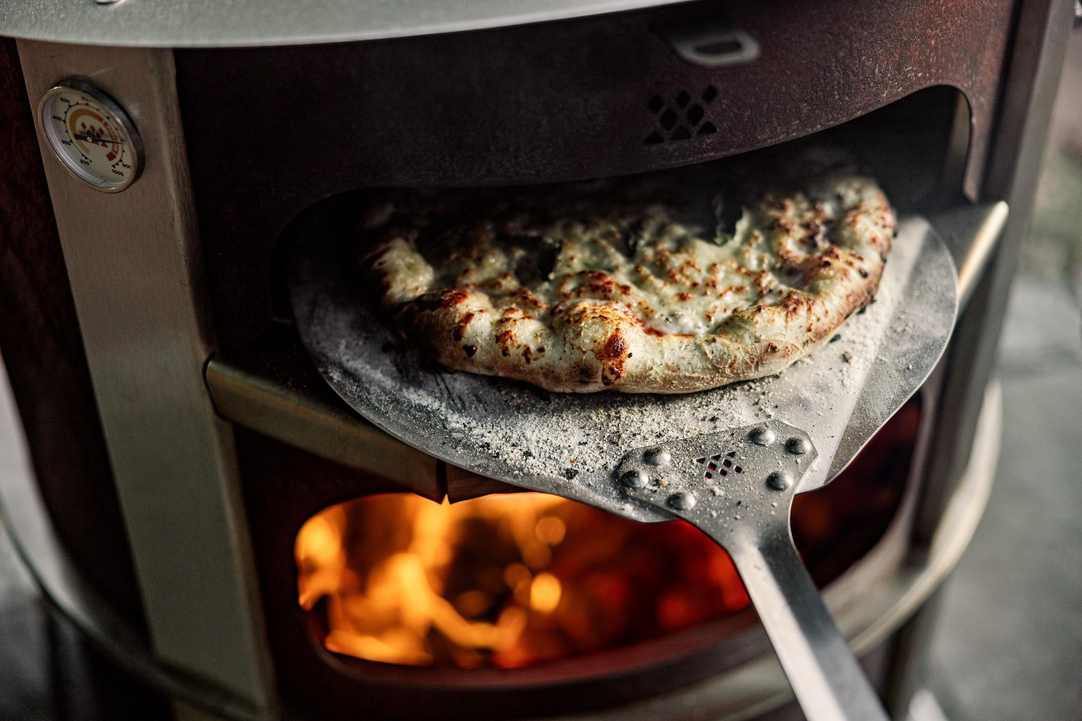 This is an image of pizza baked in the Breeo Pizza Oven