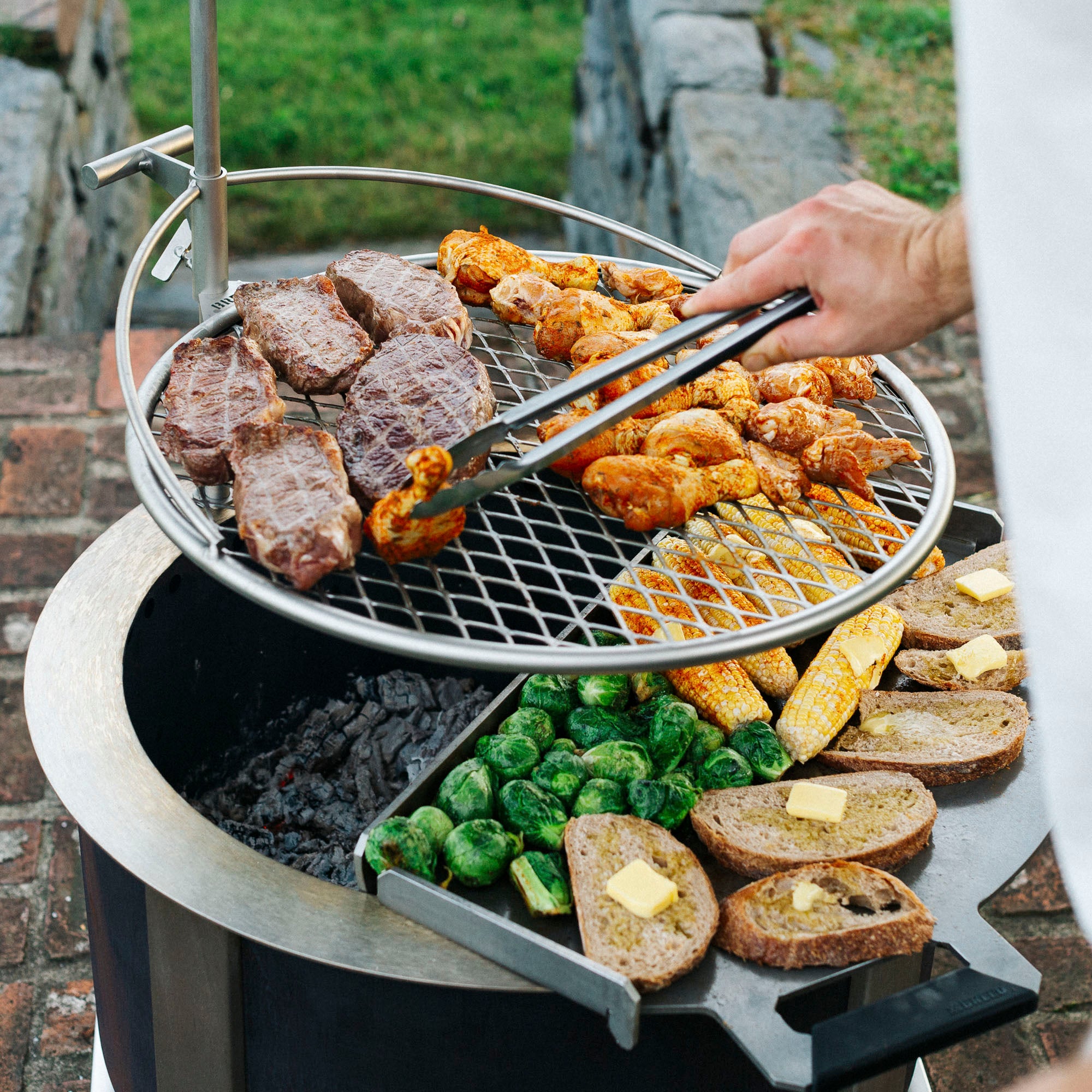 Person cooking over breeo grill 