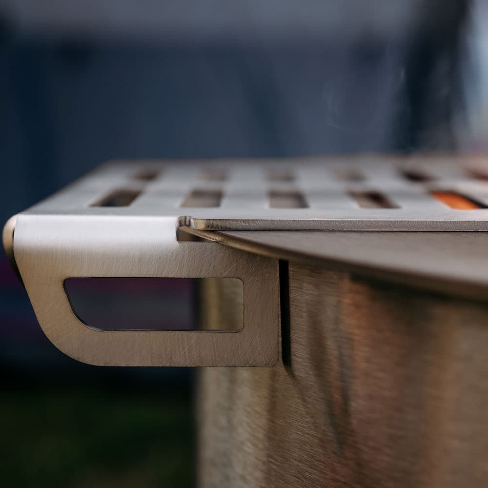 Side view of a Breeo Skillet Rest attached to the rim of a Breeo firepit