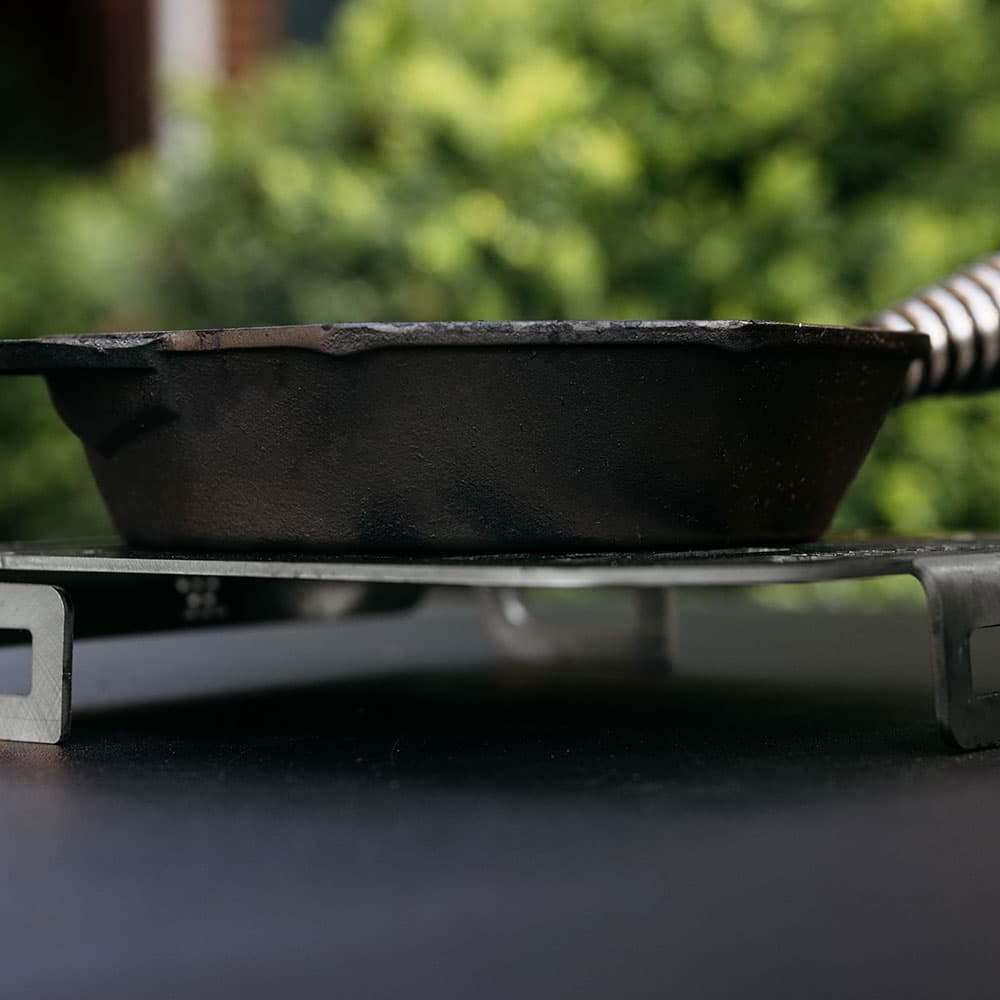A Breeo Skillet Rest used as a trivet for a Cast Iron Pan